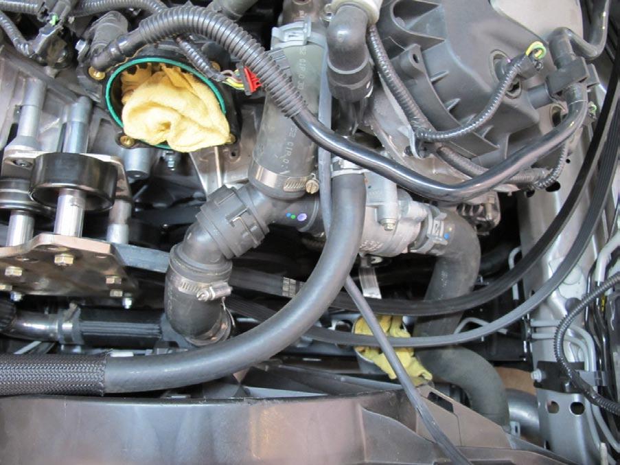 NOTE: Temporarily place rag in discharge tubing and throttle body to protect from debris