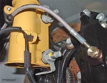 Figure 5). NOTE: When performing this step on the driver s side, make sure the brake hose support is installed on the back side of the strut tab.