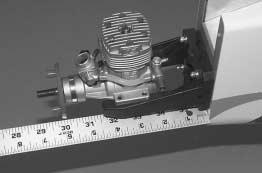 Use small clamps or another method to temporarily secure the engine to the mount with the back plate of the spinner 5-7/8" [150mm] from the firewall.
