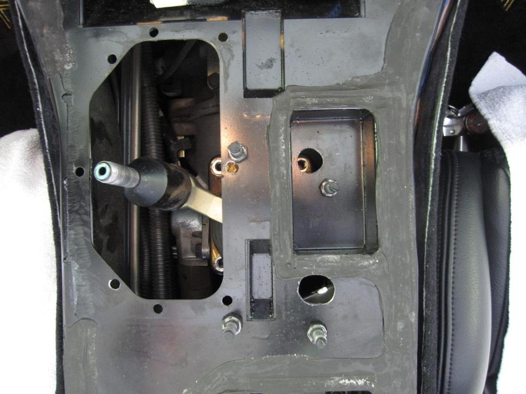 Remove the 4 shifter cover mounting bolts holding the shifter with a socket ratchet, 13mm socket,