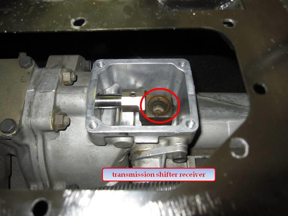 Remove gasket material from the shifter mating surface on the transmission tail shifter housing with a razor blade