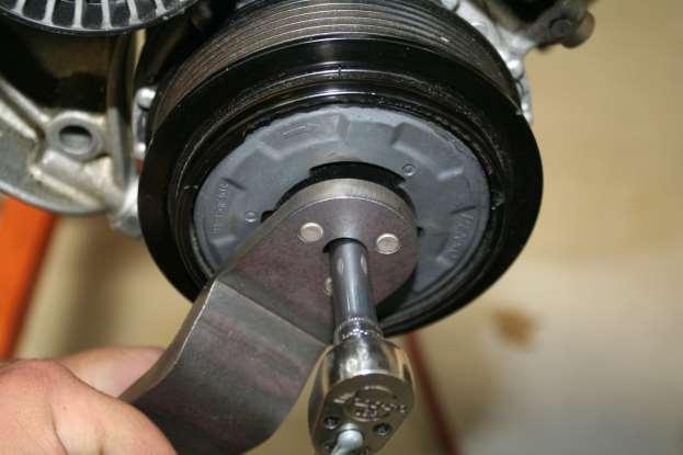 gg. Bolting on AC Pulley using the supplied AC Pulley tool and a 1/4 drive 7mm deep socket with the socket wrench set to LOOSEN/COUNTER-CLOCKWISE and torque to 10nm.