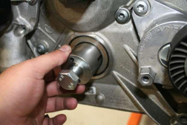 f. Applying grease or oil to the provided 7/32 drill bit and drilling the crank through the two holes in the Crank Drill Tool.