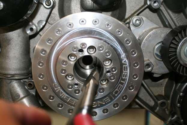 k. Using long pliers, insert the two steel dowel pins into the holes, ONE DOWEL PIN IN EACH HOLE, then press them in until they are all the way in the holes. l. Bolting in the included 8 Rib Crank Damper Bolt.