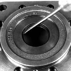 50-2 - Remove Screws Holding Flange to Housing (SAE) Fig. 50-3 - Remove Flange (SAE) 51000179 CAUTION Do not allow the output shaft to move out of the housing while removing the flange.