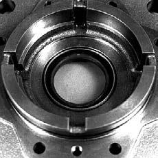 If the output shaft moves out of the housing, the synchronizing shaft and rollers could fall out of position, requiring major disassembly of the unit. Remove the old seal from the flange.