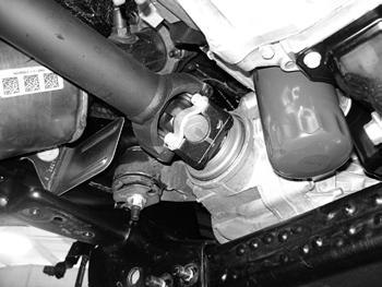 FIGURE 13 22. The driver s side rear lower control arm pocket must be cut to provide clearance for the front differential in the relocated position. This also aids in the removal of the differential.
