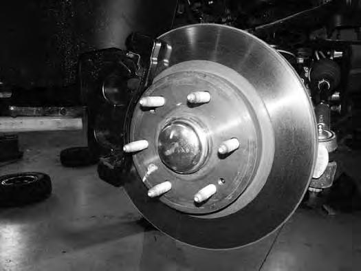 Remove the brake rotor retaining bolt and remove the rotor from the vehicle. 9. Remove the hub dust cap (Fig. 5). Remove the axle shaft nut.