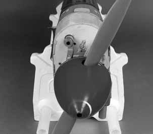 Place the spinner back plate on the engine and the propeller on the