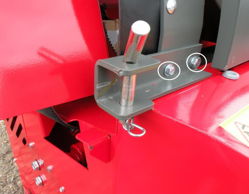 Attach the transport position holder to the splitter with two bolts as shown in