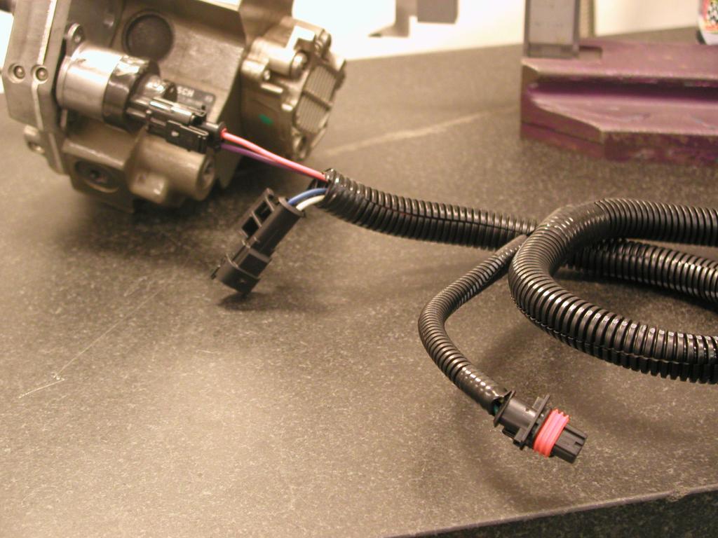 On the wiring harness provided in the kit there are four wire groups that extend out from the controller: one black lead with a ring terminal, one red lead with a fuse and a ring terminal, one lead