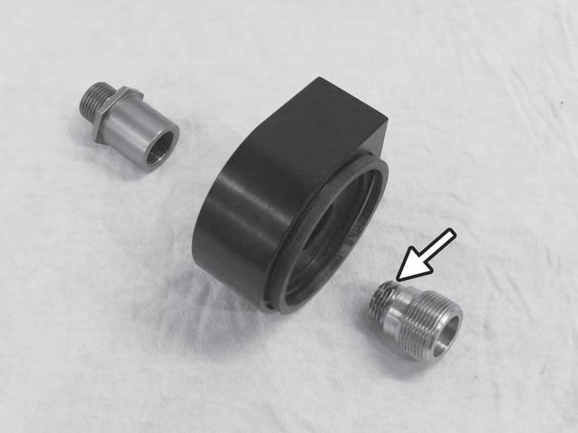 25) Prepare to assemble the oil fi lter adapter by applying a