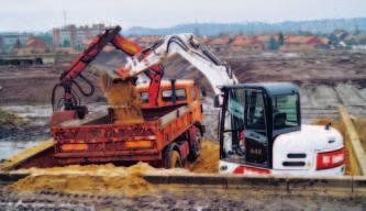 This allows the excavator to move alongside obstacles while loading at the same time