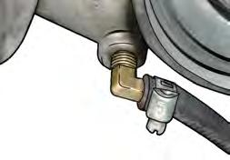 Remove the hose from the brass fitting and dispose of the crimp style clamp. 29. Using the 7/16 wrench, unscrew the stock brass fitting. 30.