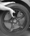10. Place the compact spare tire on the wheel-mounting