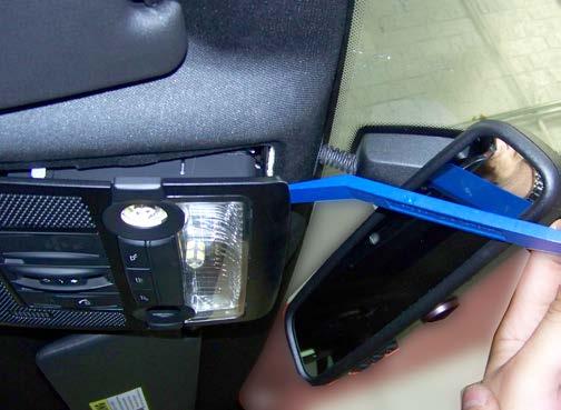 The metal clips snap against the front edge of the headliner to hold the console in place.