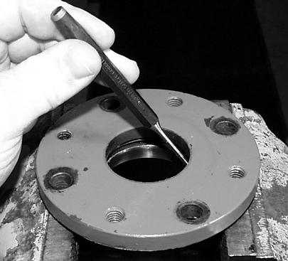 Press the input shaft seal (K) through and out of the cover using a tool that will apply pressure to the outer edges of the seal. O B L L MX0503 MX0502 13.