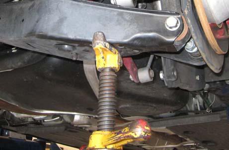 Disconnect the sensor link that is located on the driver side rear spring control arm.