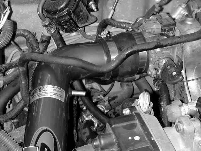 g) Position the intake pipe assembly in the engine bay so that no part touches the car. When proper fit is achieved, tighten all hose clamps and the nut on the rubber mount.