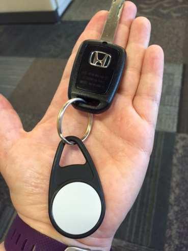 HOURCAR fob on a keychain Keypad fob: A black fob with a white circle that inserts into the keypad in the glove