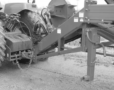 Attach safety chain to the tractor drawbar support or other specified anchor location with the appropriate parts.