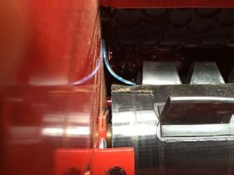Adjust tension of crescent belt in hopper to 50 inch-lbs torque on idler roller adjustment bolts or until center of belt rises off the support underneath it. Adjust both sides evenly.