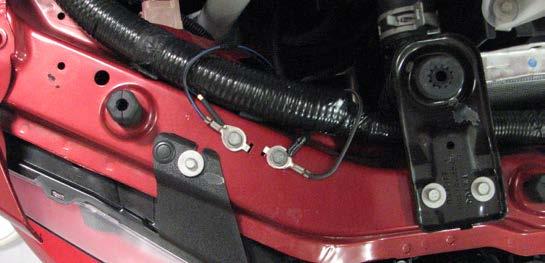 Use a 10mm wrench to remove one nut and two bolts securing the fuse box to the vehicle.