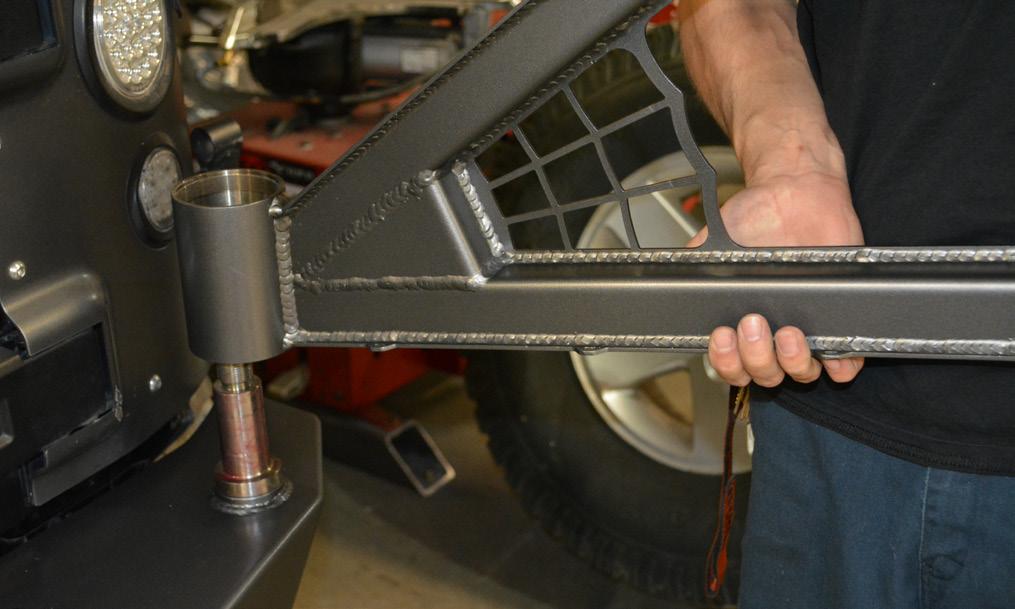 Install the Tire Carrier onto the bumper, carefully guiding the hinge housing down over the hinge spindle.