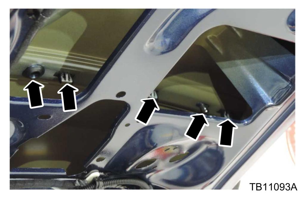 From inside the vehicle locate the applique, Ford name plate and license plate attachments and apply sealant from the