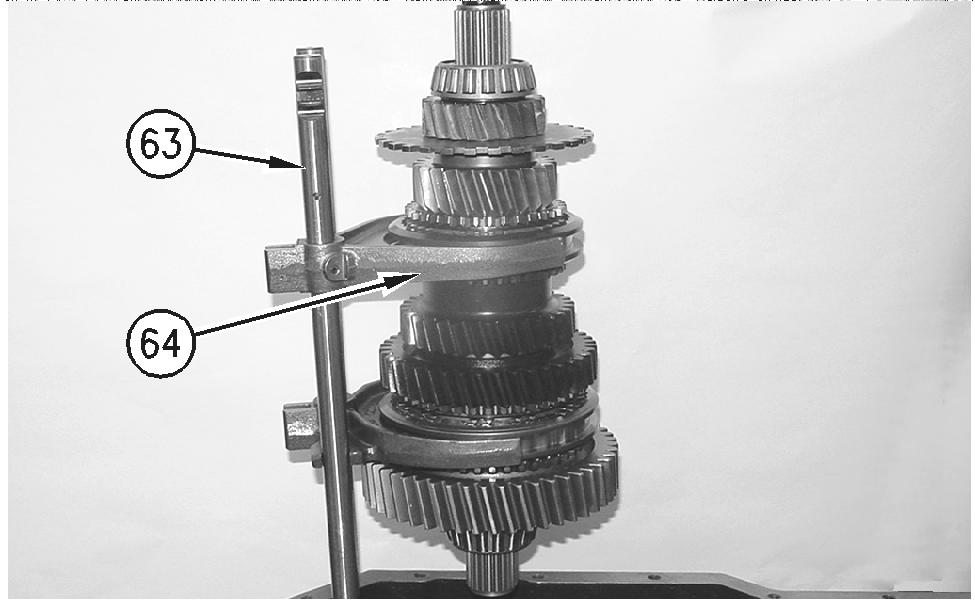 first/second speed: Sleeve (50) Strut (54) Springs (55) Outer cone (57) g00888421 Illustration 39 Output Shaft (Shown Outside of the Transmission for Clarity) (63) Shift rail (64) Fork Hub (49) The