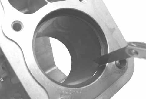 Before installing the new rings on the piston, place the top two rings, each in turn, in its running area in the cylinder bore and check the end gap. (See Figure 9-7.