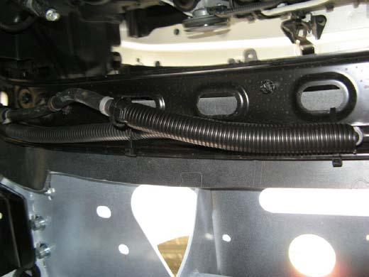 If headlight cleaner circuit is to be refitted, run hosing along the underside of the grille cross member,