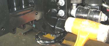 Insert clevis nut into rectangular hole in outboard face of chassis, with the notch in nut facing toward front of vehicle