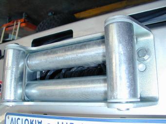 49. Lower bar down over winch, line up top holes first and secure using 3/8 hardware (1 ½ x 3/8 bolts)
