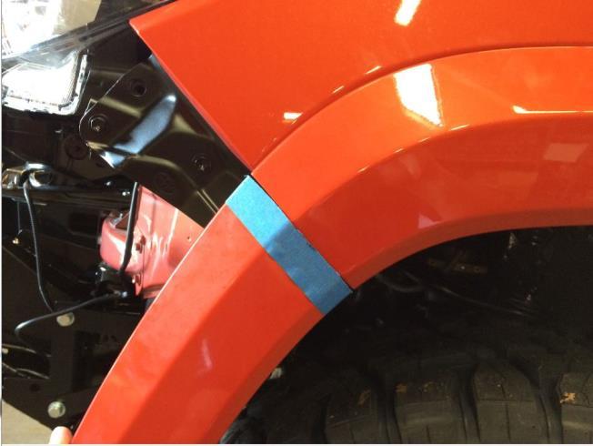Use marking tape to protect the fender flare and using the fender edge as a guide, mark the fender flare.