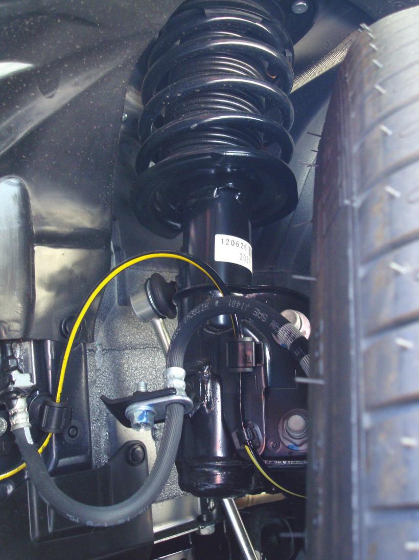 STOCK STRUT REMOVAL 1. Remove the bolts retaining the brake hose and unclip the ABS sensor wire (fig. 2).