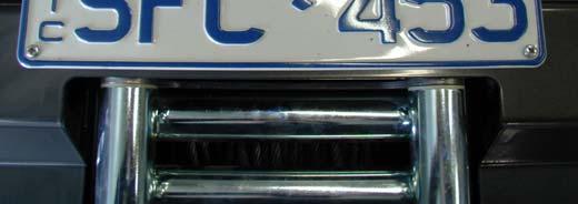Insert square grommets into holes in front of bar for licence plate