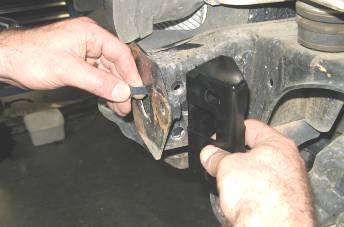 Fit one hand of a pair of reinforcing brackets up against the side of chassis and chassis end plate as shown 30.