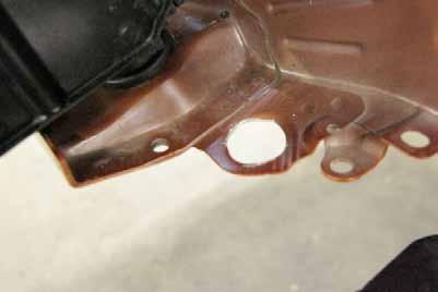 20. The windshield washer fluid tank mainly rests on a large hole at