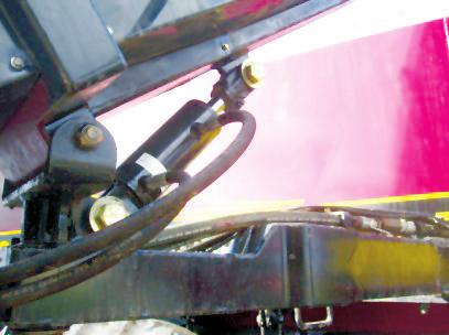 Remove pin from rear locking arm, swing out handle, and release conveyor. 4. Maneuver conveyor, using tilt cylinder first to lift conveyor out of the front saddle. 5.