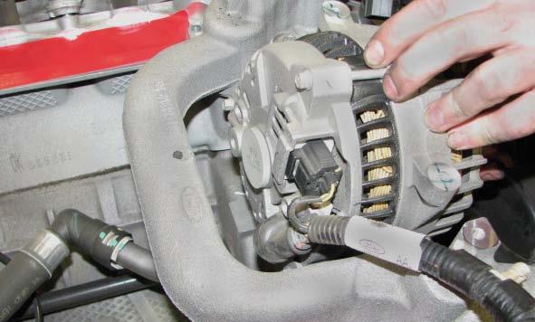 Use a 10mm socket to remove the two outer alternator bracket bolts, and an 8mm socket to