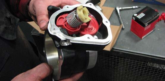 Use a T20 Torx driver to remove the motor housing, plastic capped spring, and TPS from the OEM throttle body.