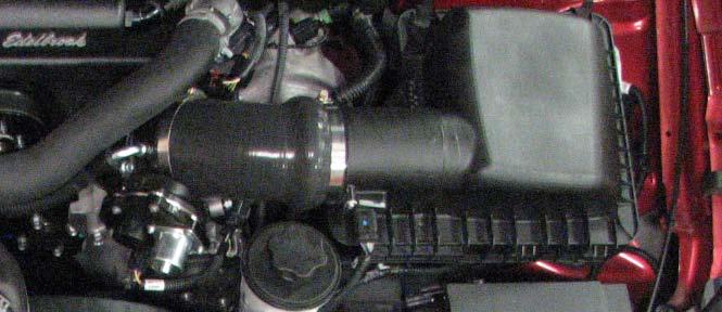 144. Install the throttle body elbow onto the throttle body and secure it with the provided hose clamps.