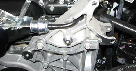 Using a vice clamp or equivalent, install the bushings onto the supplied alternator bracket as shown.