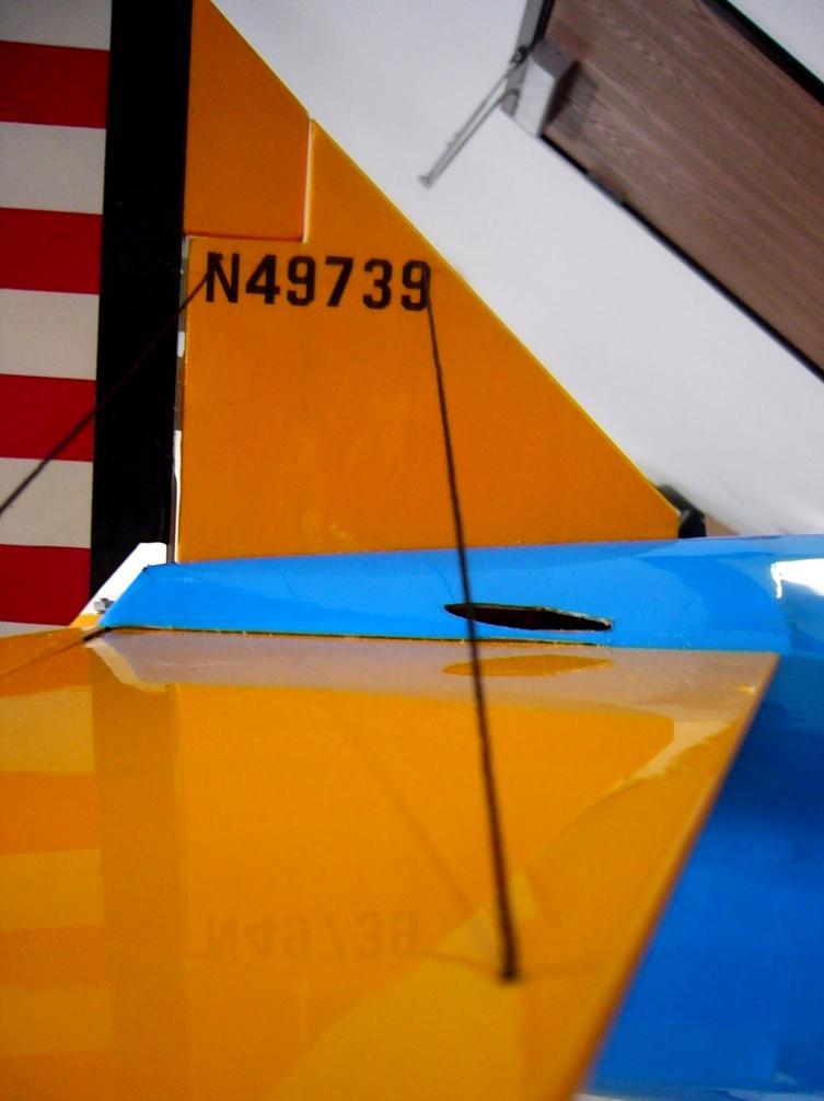 Install the empennage wires (black string): If necessary, open six small holes under the Mylar in the tail section (2 near the top of the vertical stabilizer and 2 in each half of the horizontal