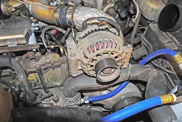 Step : Using a 0mm wrench, disconnect the alternator wire.