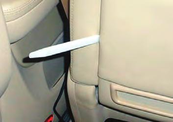 On right and left sides of the lower portion of the seatback, insert a flat bladed tool between the seatback and the seat
