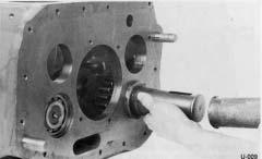 2. Set reverse gear in position next to washer, machined surface of gear hub to