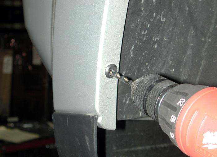 Using a ¼" drill bit, drill out the center of the two pop rivets (on each side) which hold the fender liner to the fascia (Fig.E).