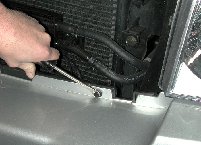 At the bottom of the fascia, remove the three 10mm (head) bolts connecting the fascia to the radiator support (Fig.G). 7.